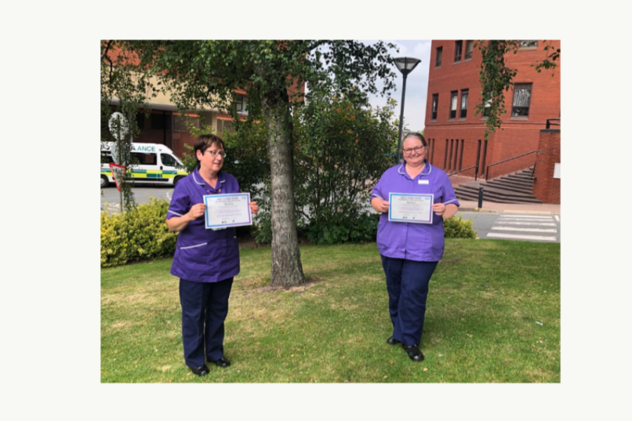 nurses holding HMP micro-elimination certificates